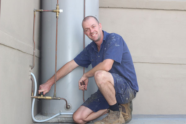 Dave installing a hot water heater in Kiama.